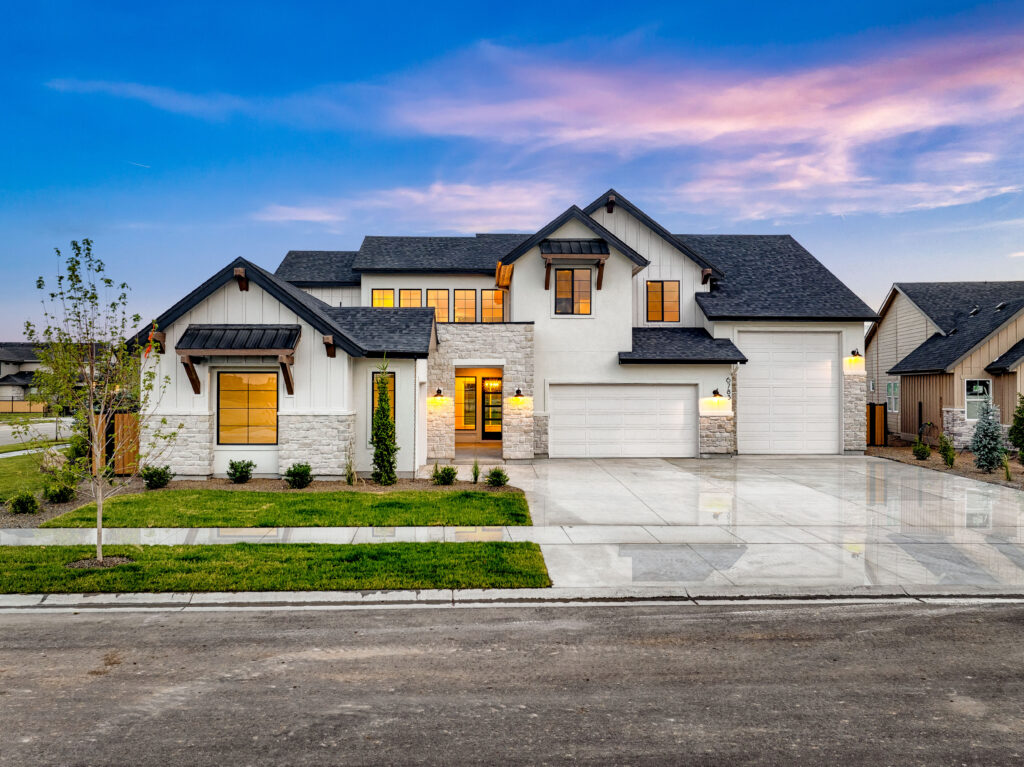 Beautiful white home with lush grass and RV garage
