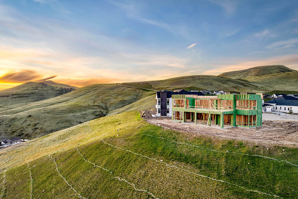 Home being built on a hill with a beautiful skyline behind it.